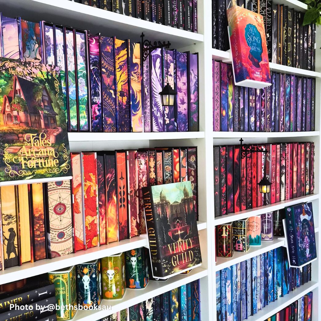 Fantasy special edition hardcovers on white bookshelf with custom painted edges and 3D printed floating book display ledge holding Tales of Arcana and Fortune.