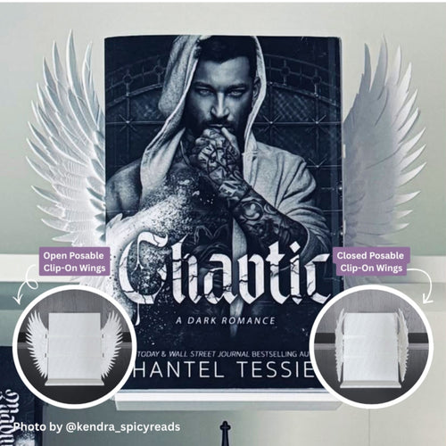 Curio Clip-On White Feathered Angel Wings attached to the Curio Candy Floating Book Display Hanger, fitting snugly on a bookshelf behind Shantel Tessie's Chaotic book cover, ideal for dark romance and spicy book displays, with open and closed posable wing options.