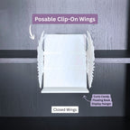Curio Clip-On Angel Wings shown in the closed position attached to a Curio Candy Floating Book Display Hanger mounted on a bookshelf.