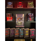 Curio Clip-On Gothic Demon Bat Wings attached to a Curio Candy Floating Book Display Hanger, styling Sarah J. Maas's House of Sky and Breath on a posable dark romance bookshelf display.