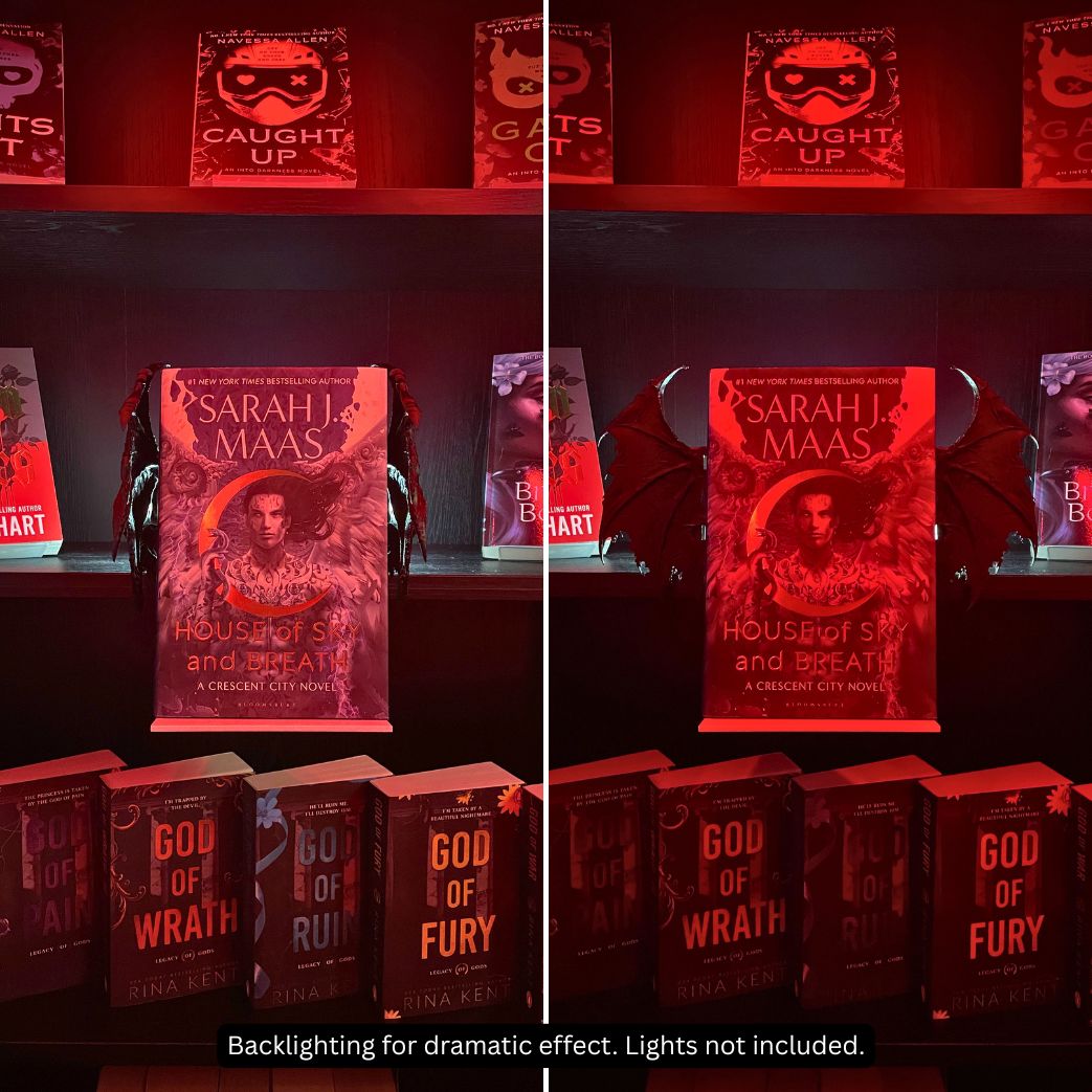 Side-by-side comparison of posable Curio Clip-On Gothic Demon Bat Wings in closed and open positions attached to a Curio Candy Floating Book Display Hanger under dramatic red lighting.