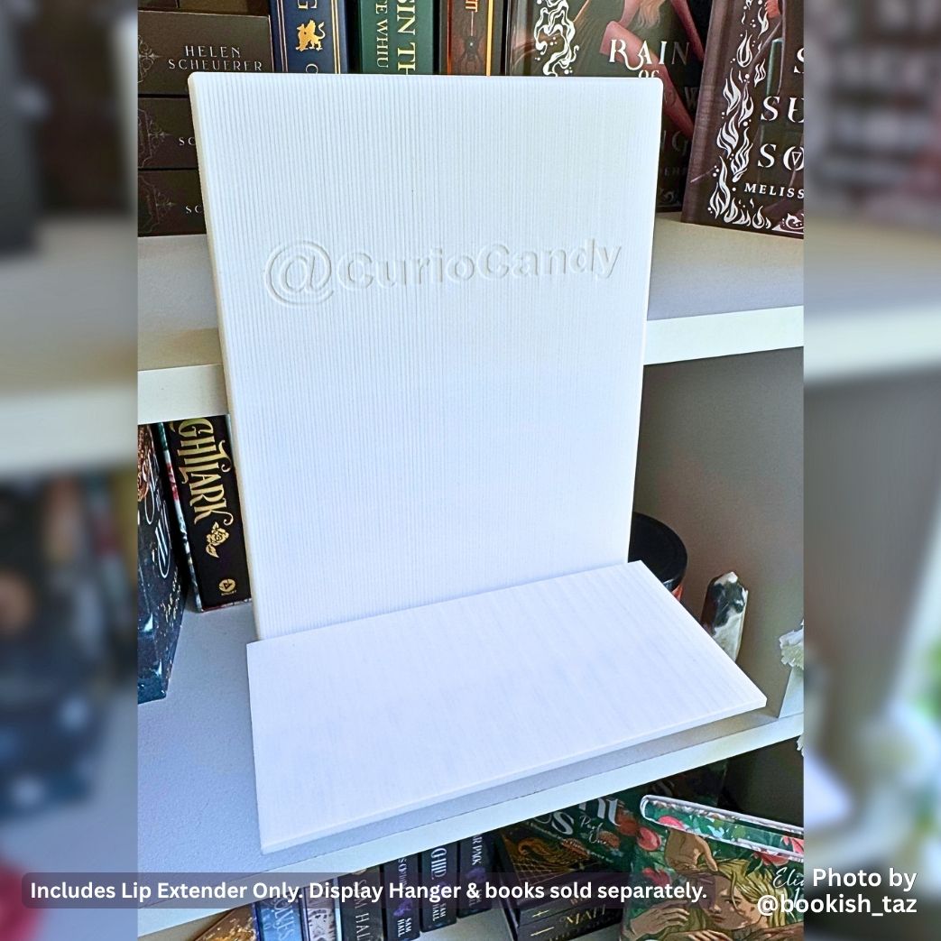 Perspective view of a white 3D printed 80mm Deep Lip Extender attached to the base of an empty white Curio Candy Floating Book Display Hanger on a bookshelf.