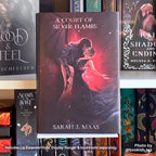 Front view of the hardcover novel A Court of Silver Flames by Sarah J. Maas displayed securely on a white Floating Book Display Hanger with an 80mm Deep Lip Extender.
