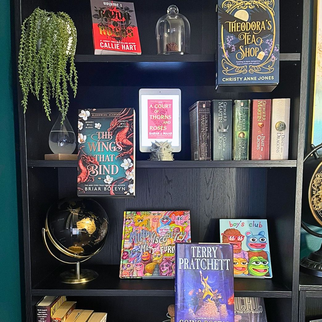 Curio Candy floating book display hangers presenting fantasy special edition novels on black IKEA Billy bookshelf decor display.